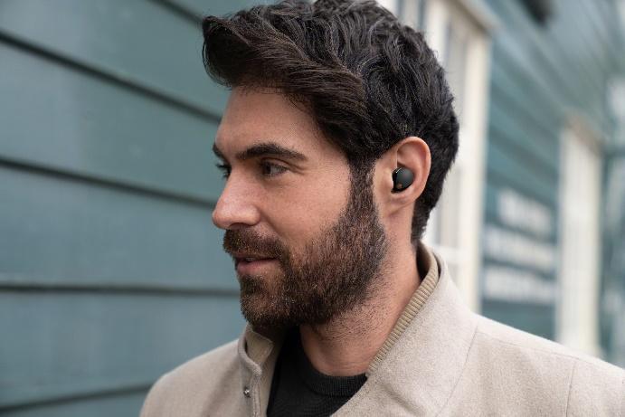 A person with a beard wearing a wireless earbud

Description automatically generated with medium confidence
