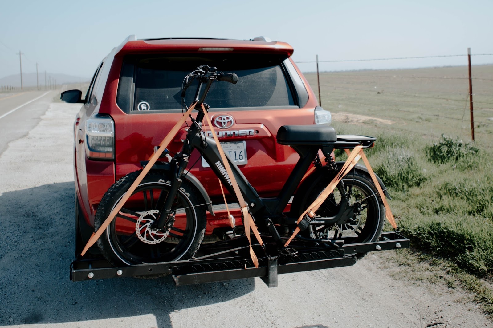 [Alt. Text: A picture of a car with a bike rack broken down on the side of the road.]