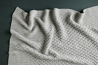 cable knit blanket lying flat