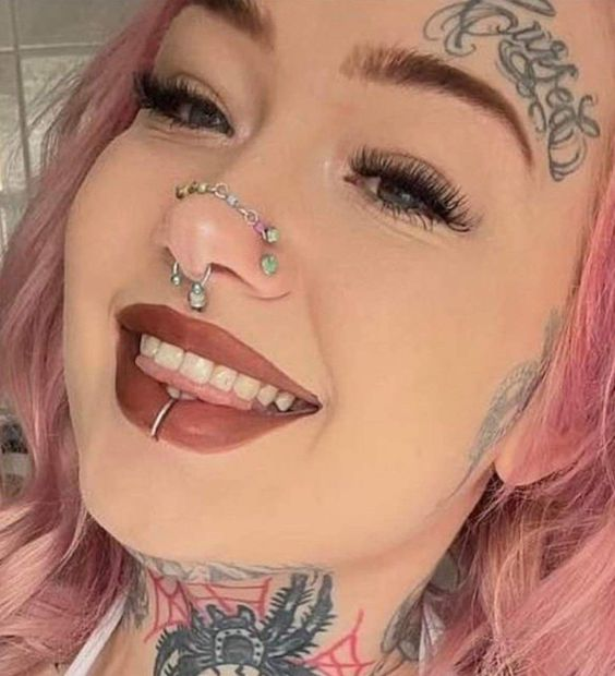 Picture of a lady smiling with her beautiful piercings