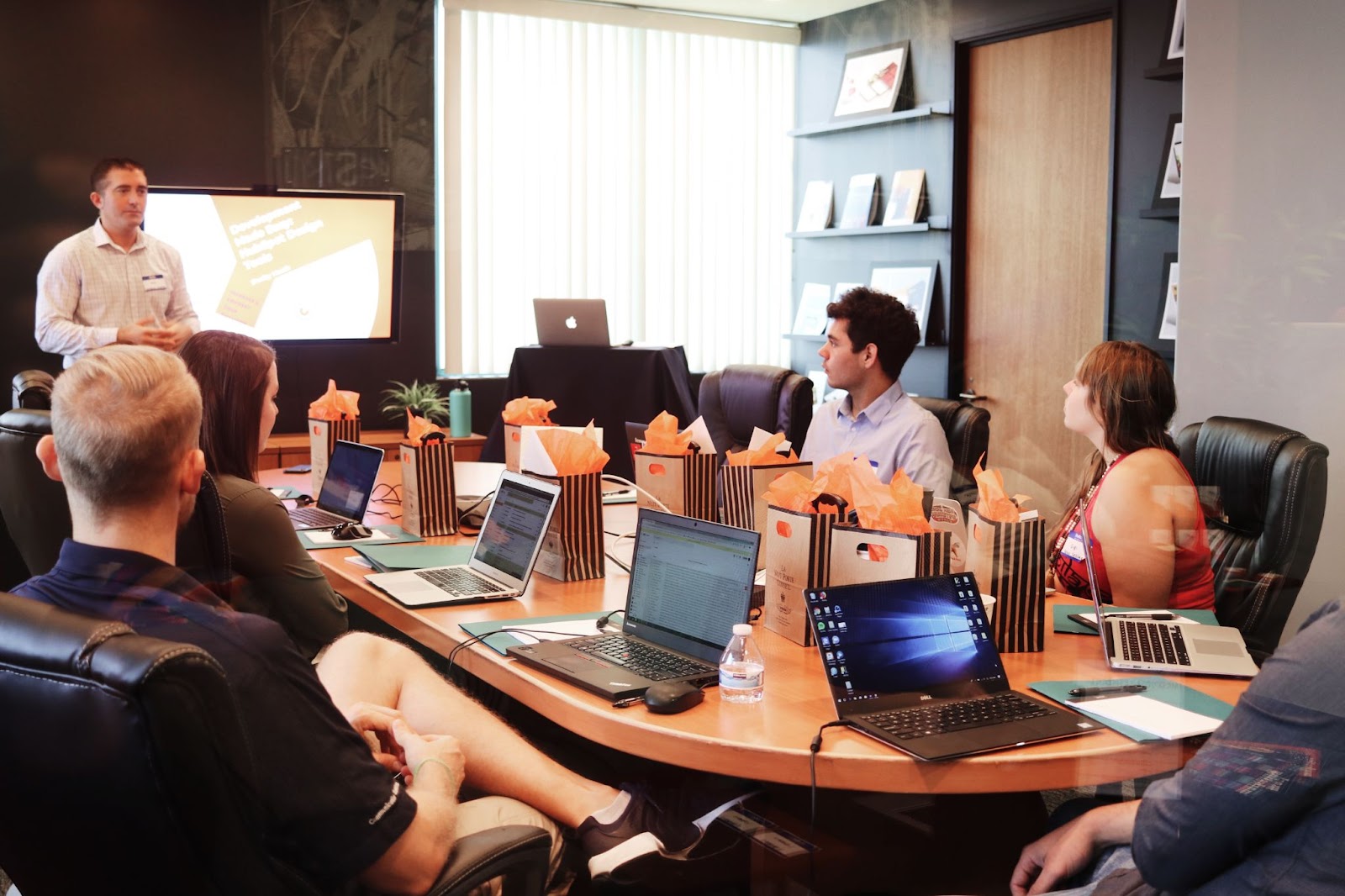 People sat in a board room having a meeting. 