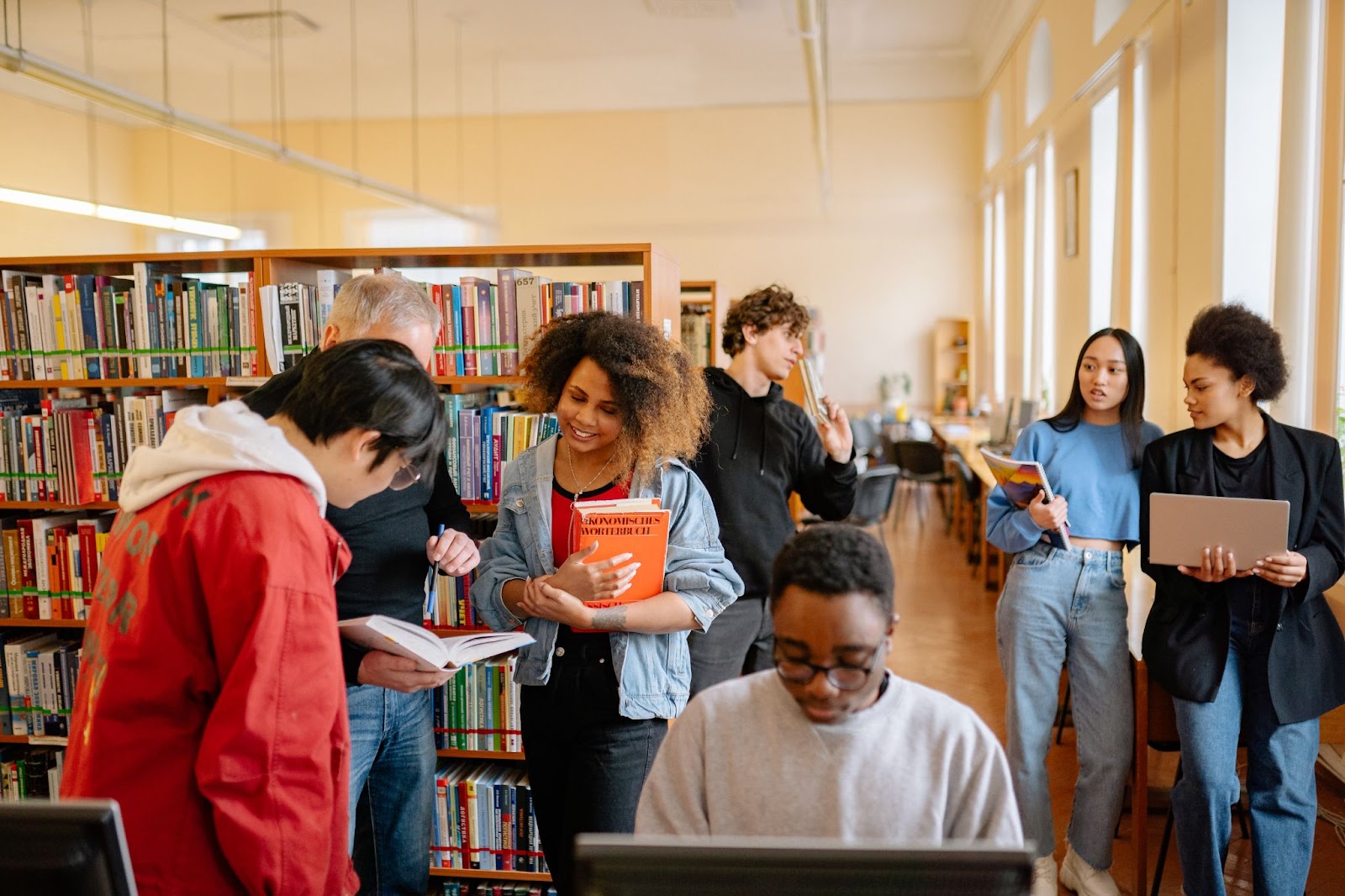 A bunch of students studying in a library.