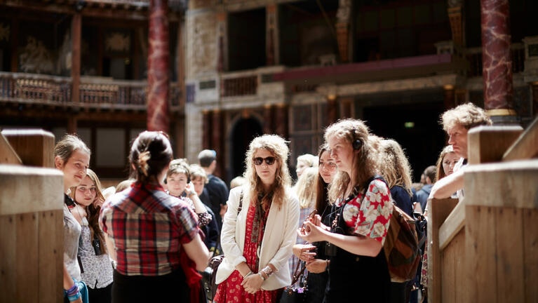 A group of visitors await the start of a play at Shakespeare's Globe