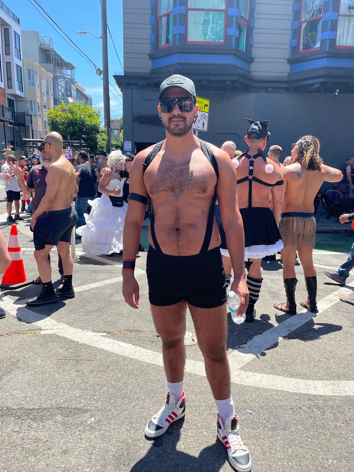 gay half naked male wearing black shorts and high top sneakers in SF Dore alley 2023 street fair
