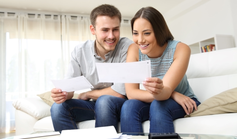 a couple smiling at their relocation checks