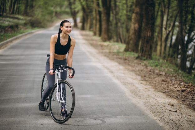 A person riding a bicycle on a road

Description automatically generated