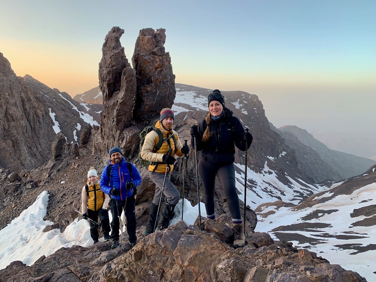 Hikers pose in the High Atlas Mountains at sunrise.