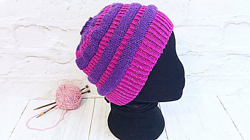pink and purple messy bun hat knitting pattern on mannequin head