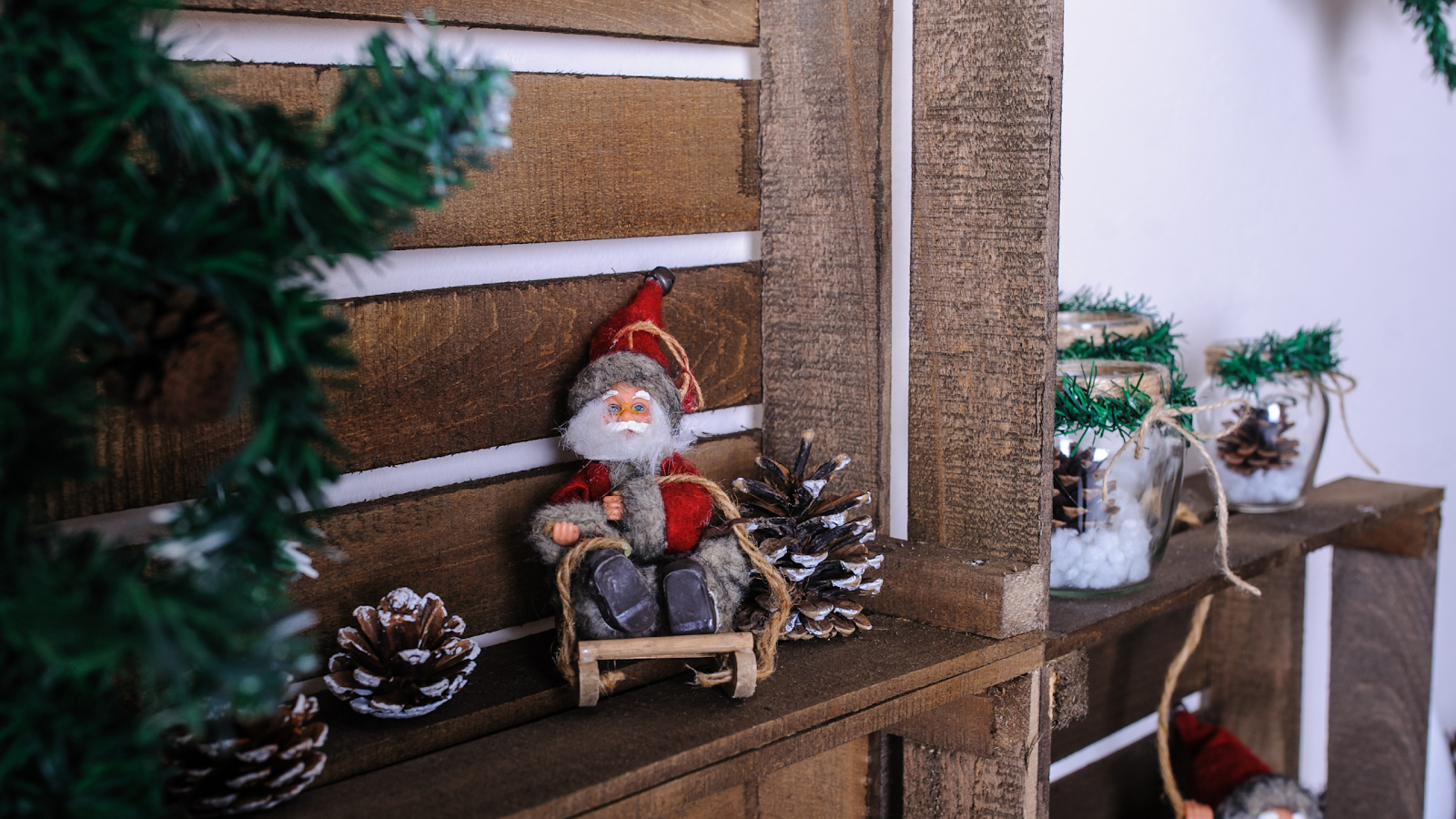Wood-inspired Christmas decors at home in the living room with a santa clause, trees, and wooden wall finishes in a condo for sale
