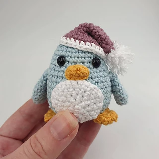 very small crochet penguin with santa hat