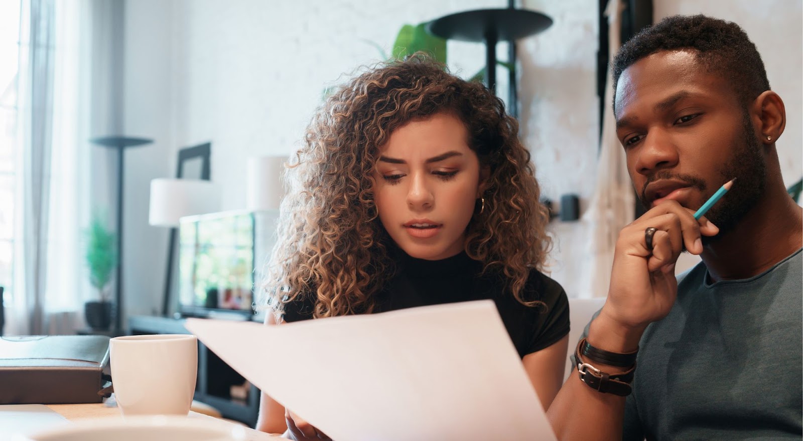 Man and woman sitting at table, making a vacation emergency plan 