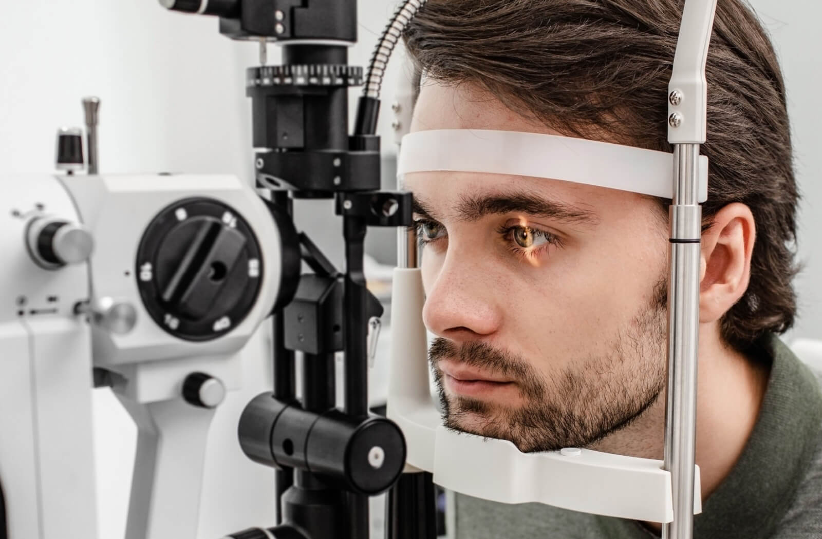 An eye doctor tests a woman's eyesight with the Snellen eye chart
