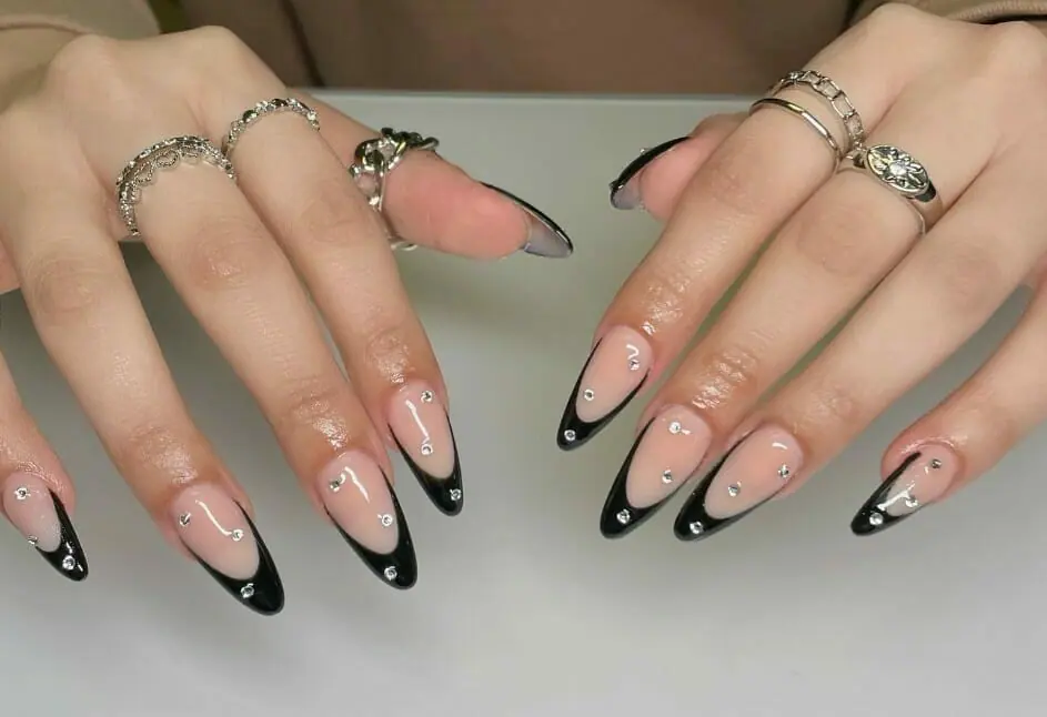 Close up view of the black and whit nails with giltters