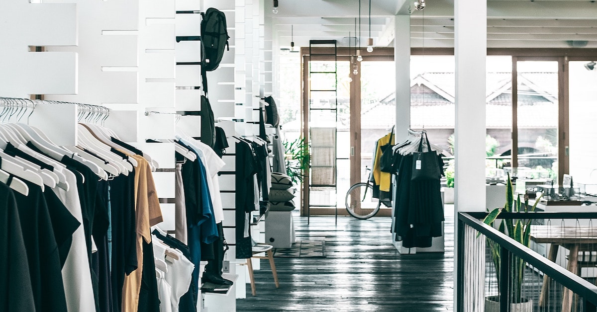 Interior of a clean and minimalist clothing store.
