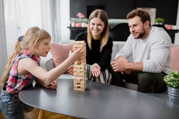 A family spending time by playing Jenga.