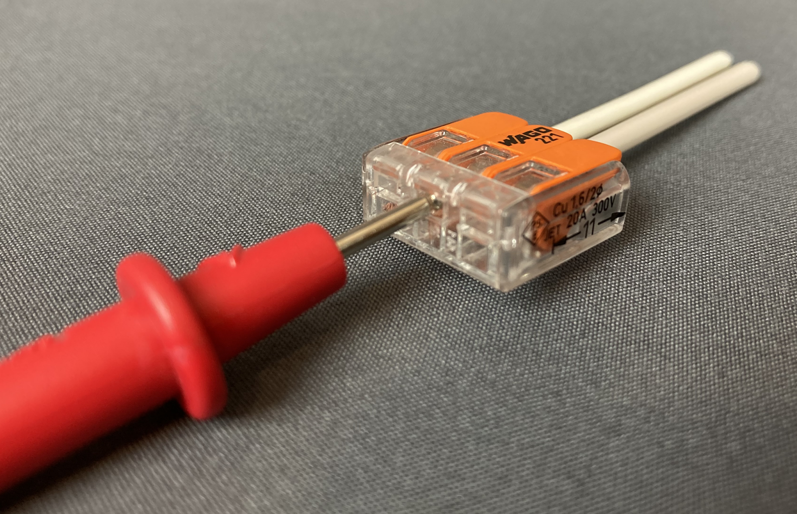 All lever-nuts contain a  protected test probe port in the middle of the back edge. wire connector.