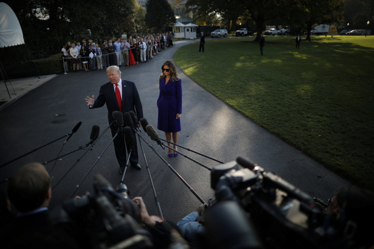 U.S. President Donald Trump talks with reporters accompanied by First Lady Melania Trump as they depart the White House for a trip to Asia, in Washington D.C., U.S. November 3, 2017. REUTERS/Carlos Barria