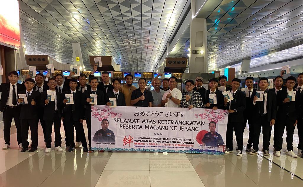 A group of people holding a bannerDescription automatically generated