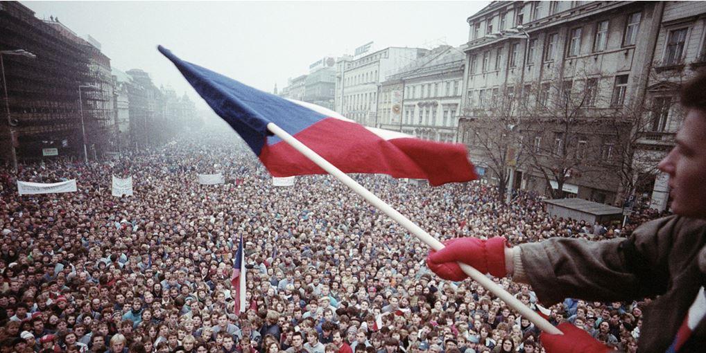 A person holding a flag in a crowd of people

Description automatically generated with low confidence