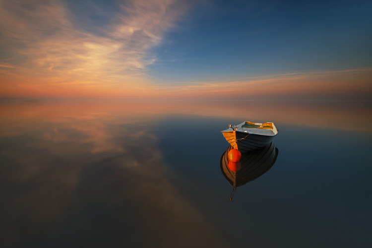 lonely-boat-in-the-middle-of-sea-water.jpg