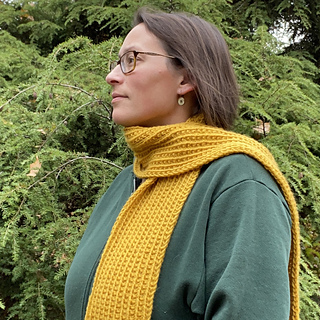 woman wearing a mustard colored knit scarf outside