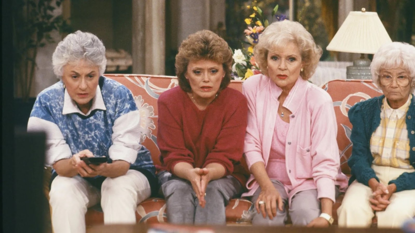 The four characters of The Golden Girls are staring very seriously at a television set during one of the scenes in The Golden Girls.