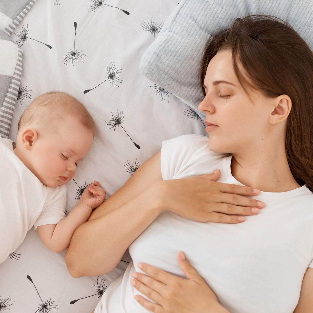 Mother and her baby sleeping beside each other