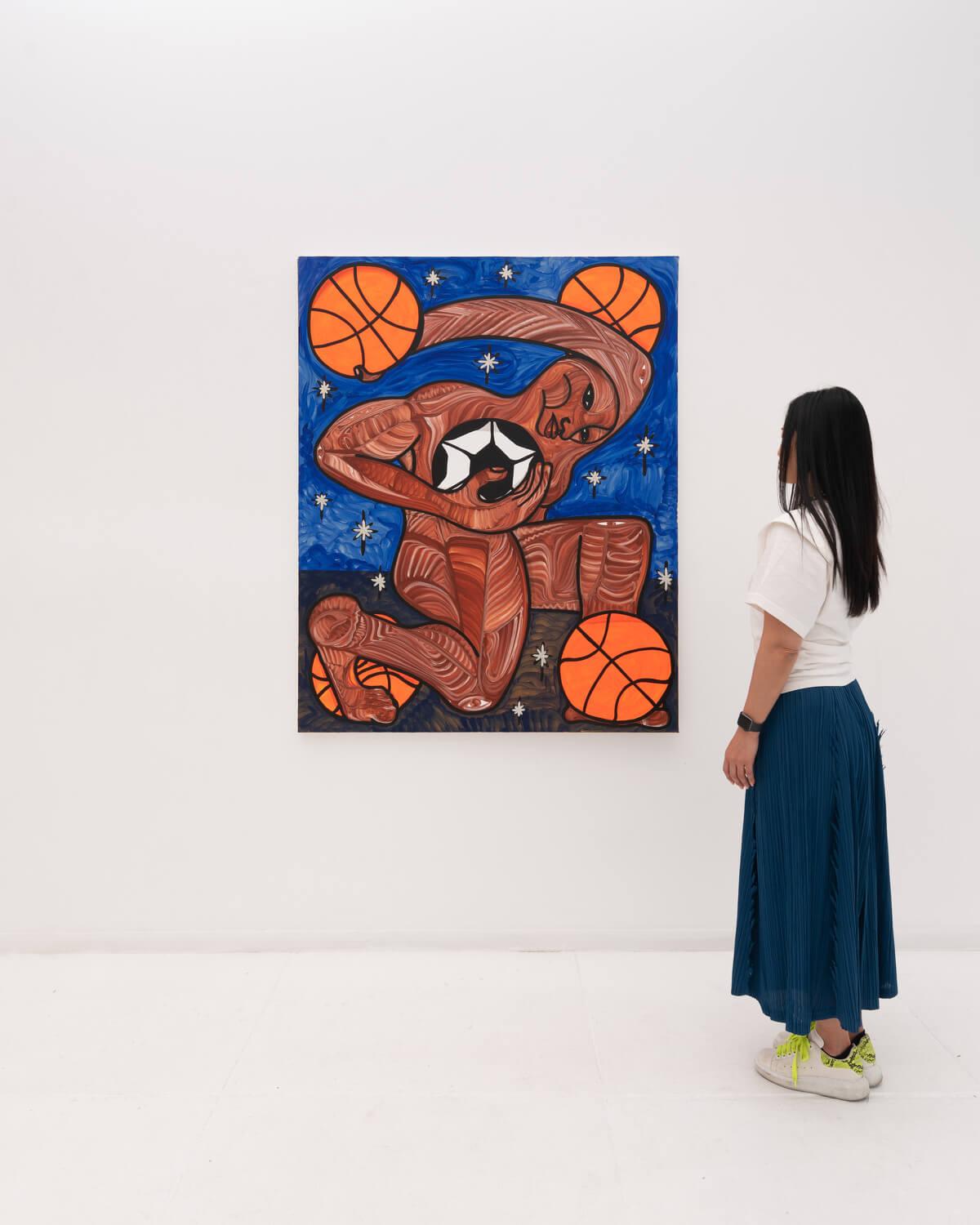 A person looking at a painting

Description automatically generated