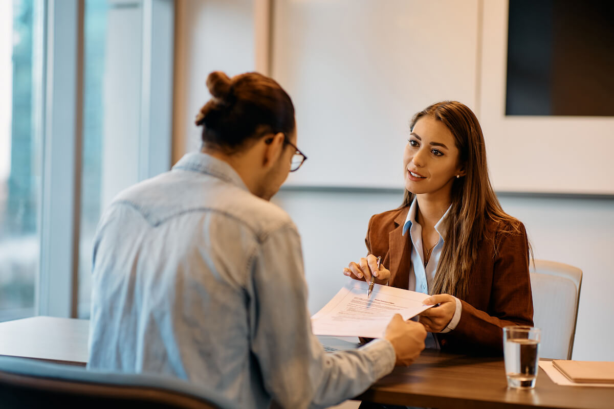 Leave management system: manager explaining a contract to an employee