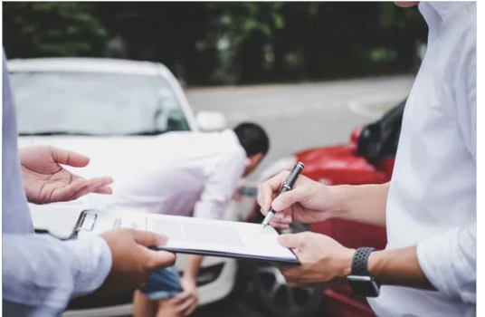 two people going over an auto insurance policy