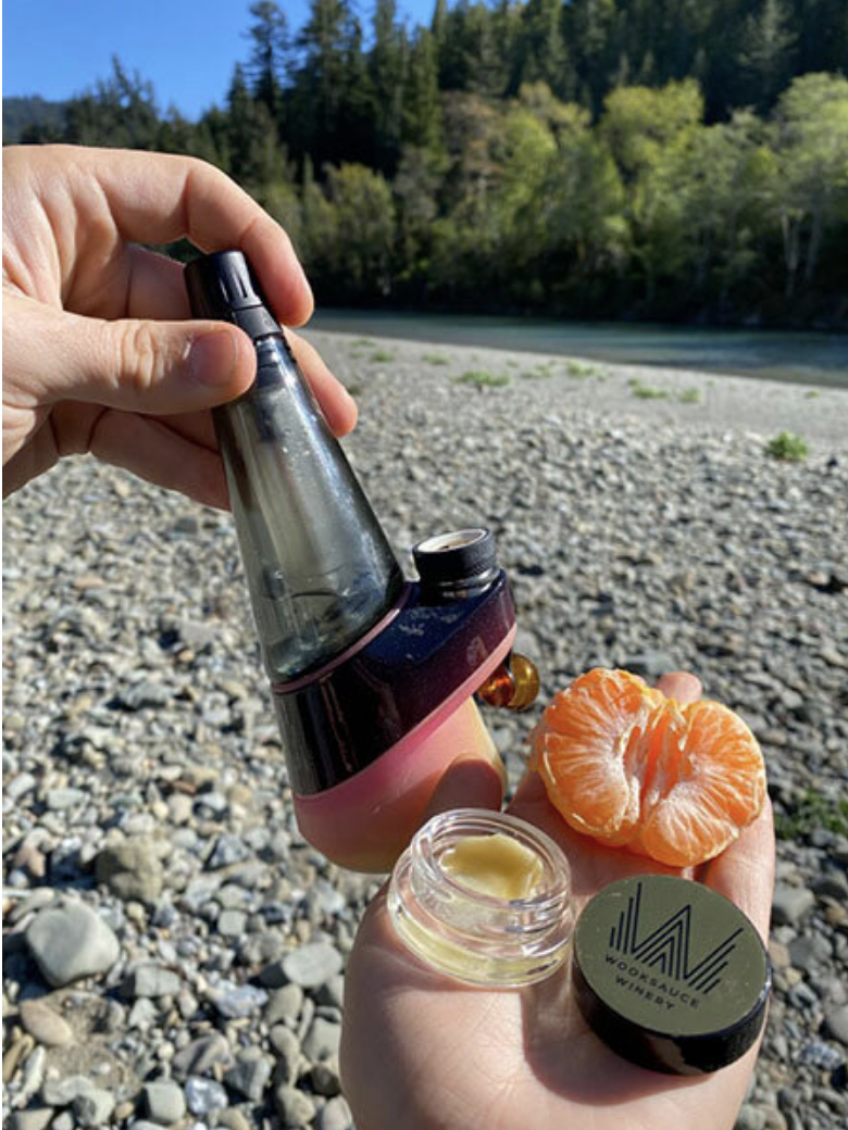 Enjoying our Peak oil vaporizer from Puffco, with a clementine in front of the river
