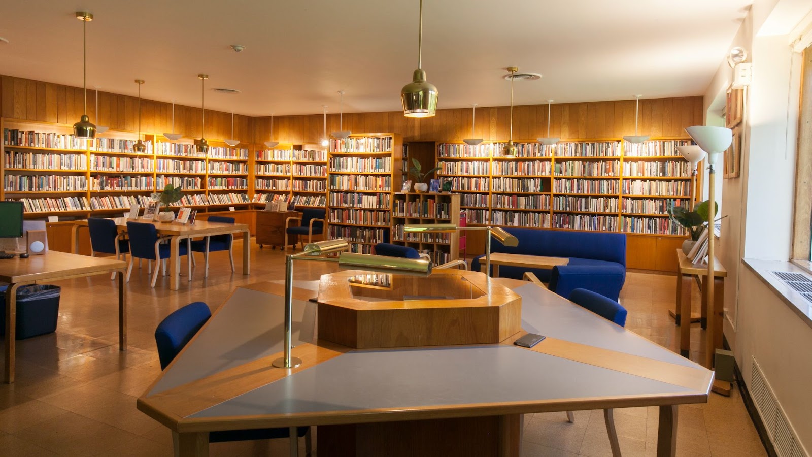 a room full of books and desks