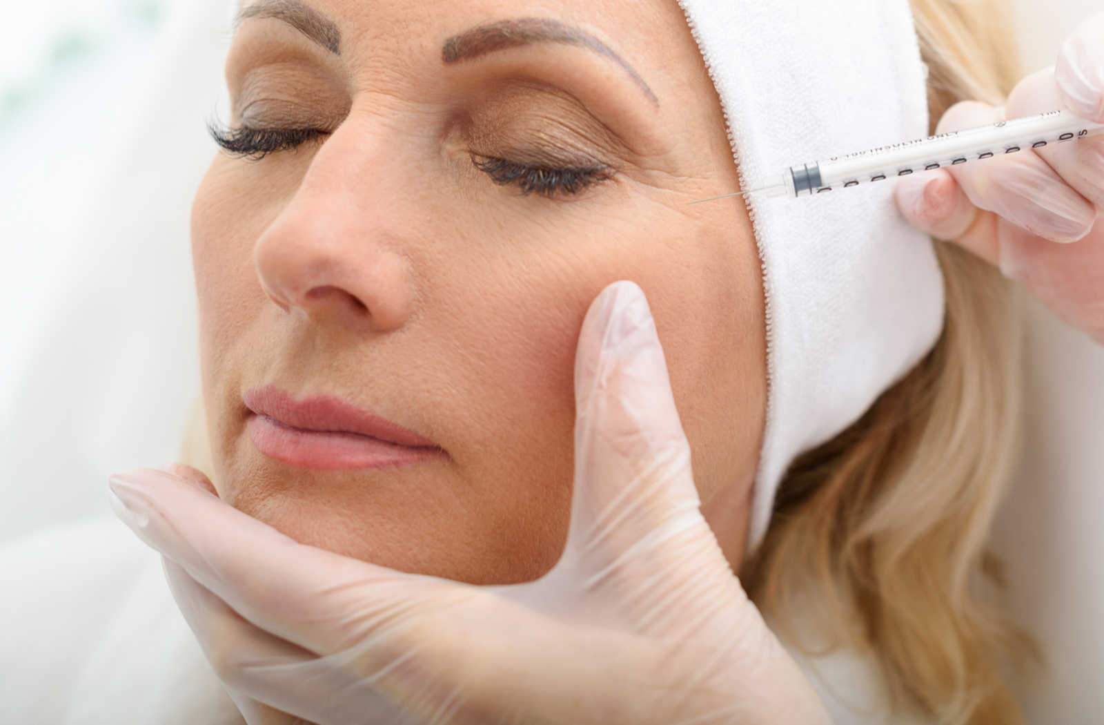 woman getting botox injections to treat her crow's feet