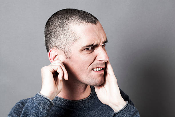 Man pinching ear