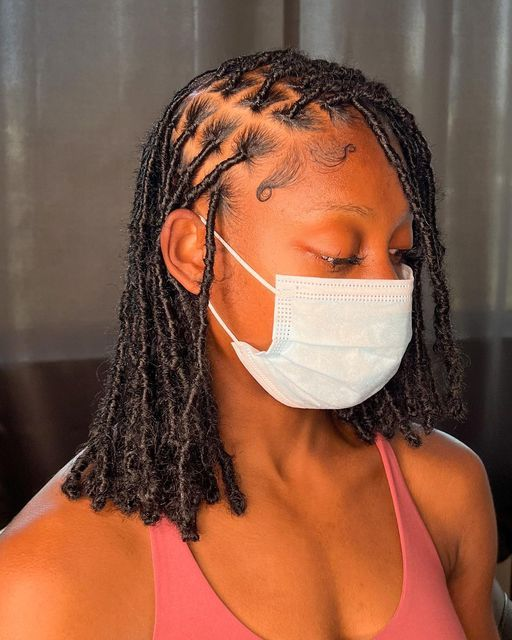 Lady on mask show off her soft locs