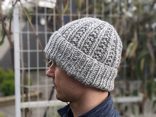 man wearing gray knit hat made from chunky yarn