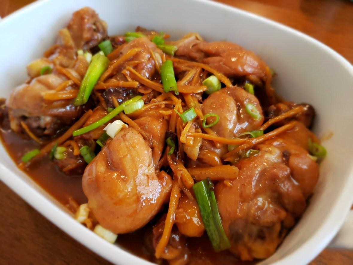 A white bowl filled with meat and vegetables on a plate

Description automatically generated