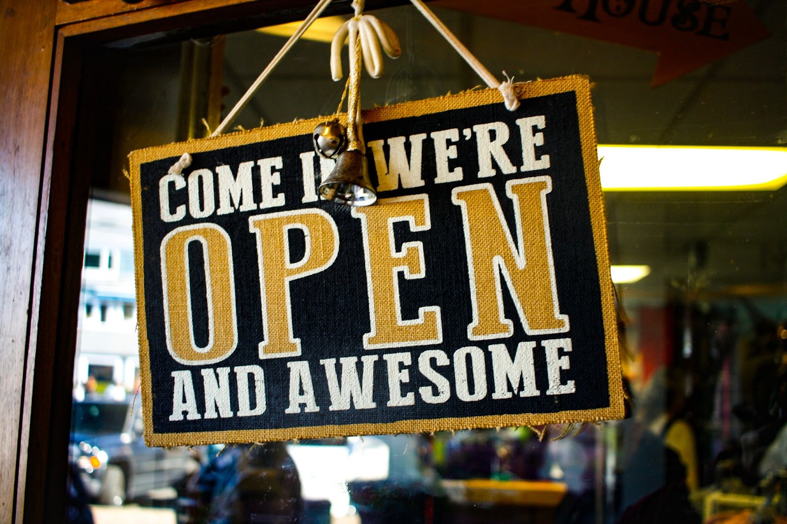 Sign bearing 'come in we're open and awesome'