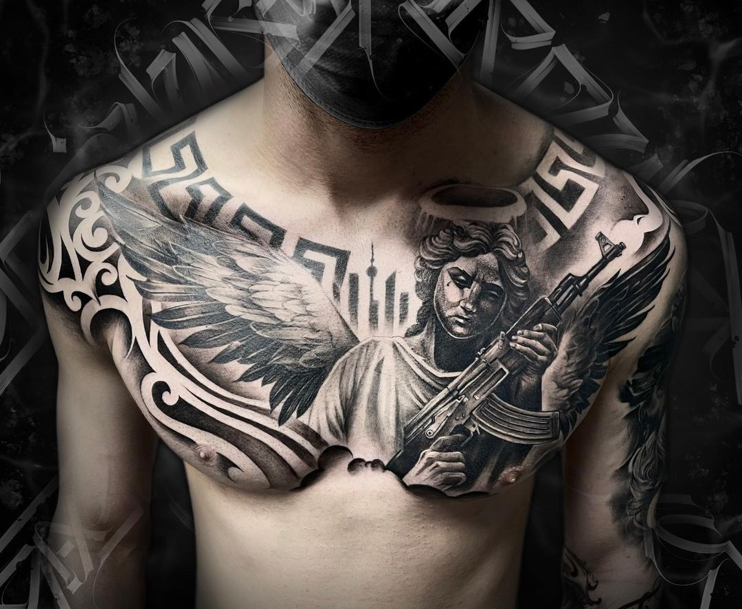 Angel With Gun Tattoo On Chest