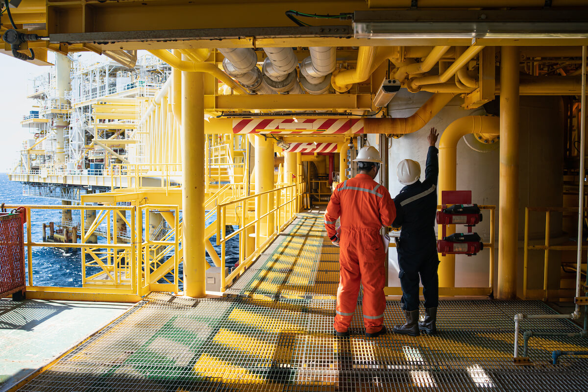 2 workers checking a pipe