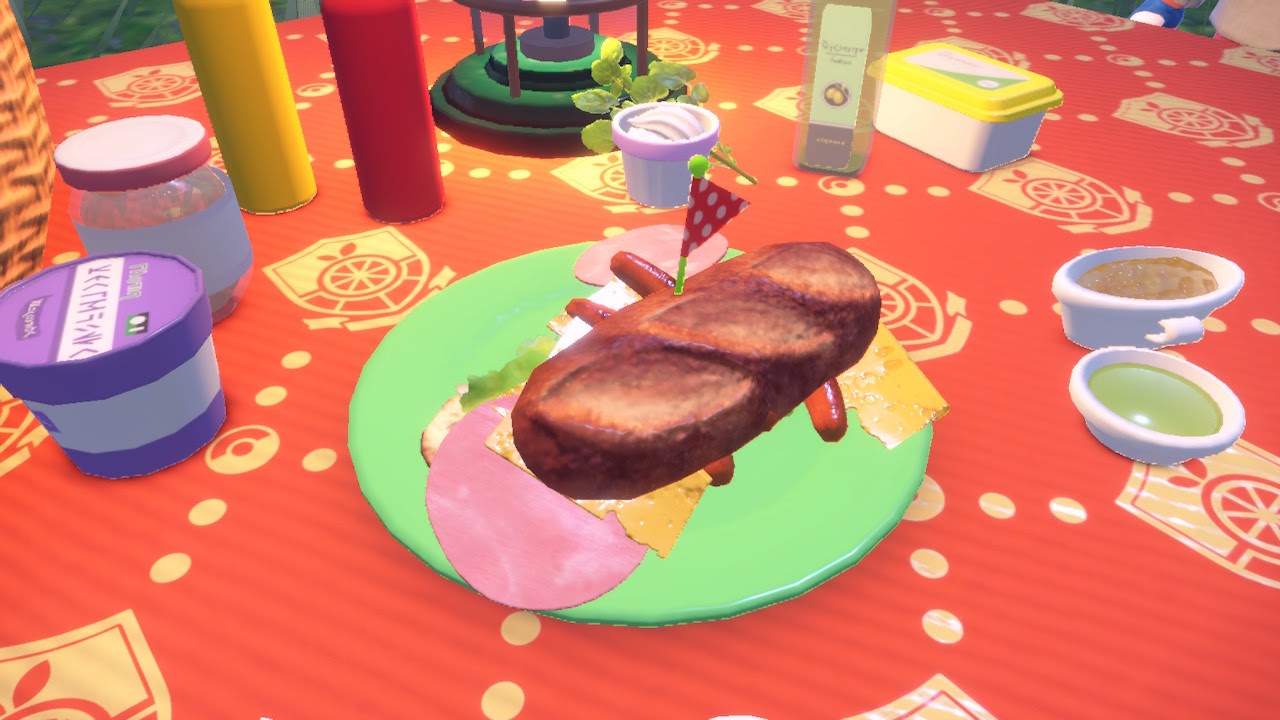 A monster of a sandwich slides off a picnic plate