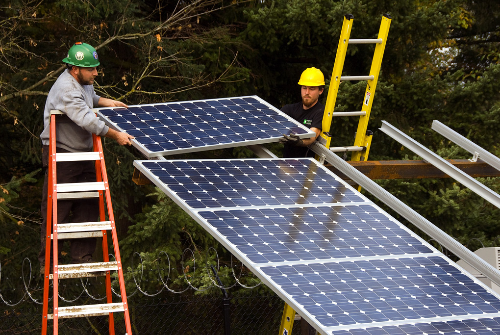 Installing solar panels | Workers place a solar panel into p… | Flickr