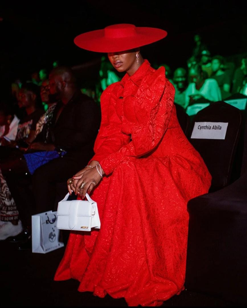 Angel Obasi expressing her signature style in an all-red ensemble with a hat