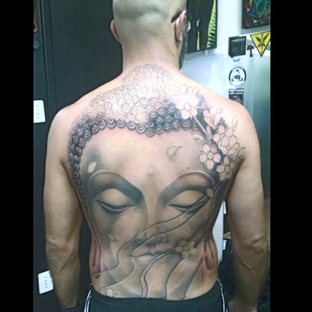 Waves And Buddha Head Tattoo On Back Body