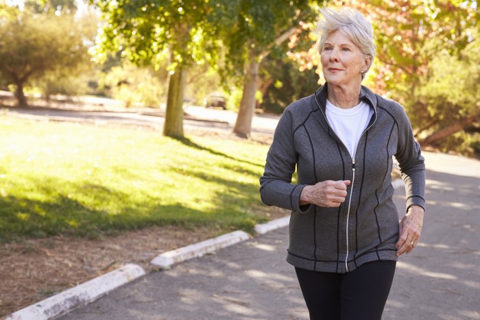 Senior woman jogs in park for a healthy heart