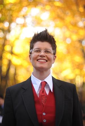 A person wearing a suit and tie Description automatically generated