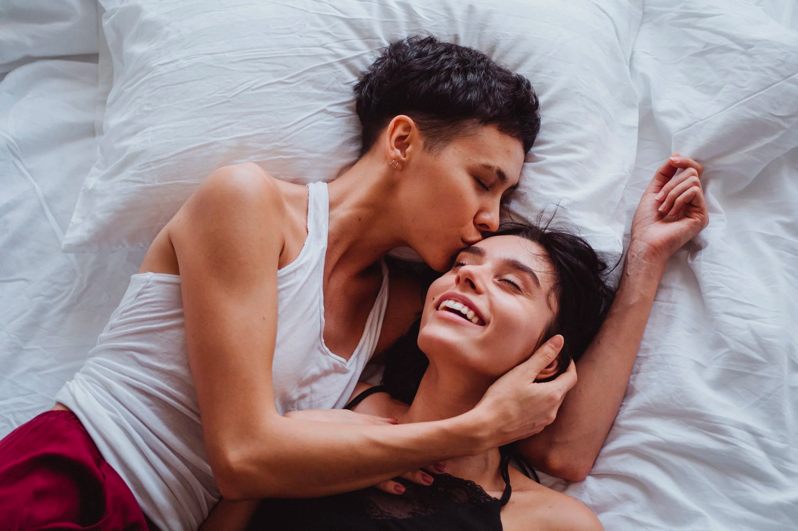 A woman with healthy lips kissing another woman