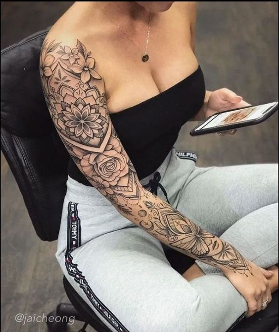 a woman wearing flower-themed sleeve tattoo
