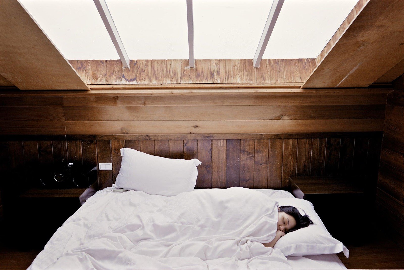 woman sleeping in a wooden room