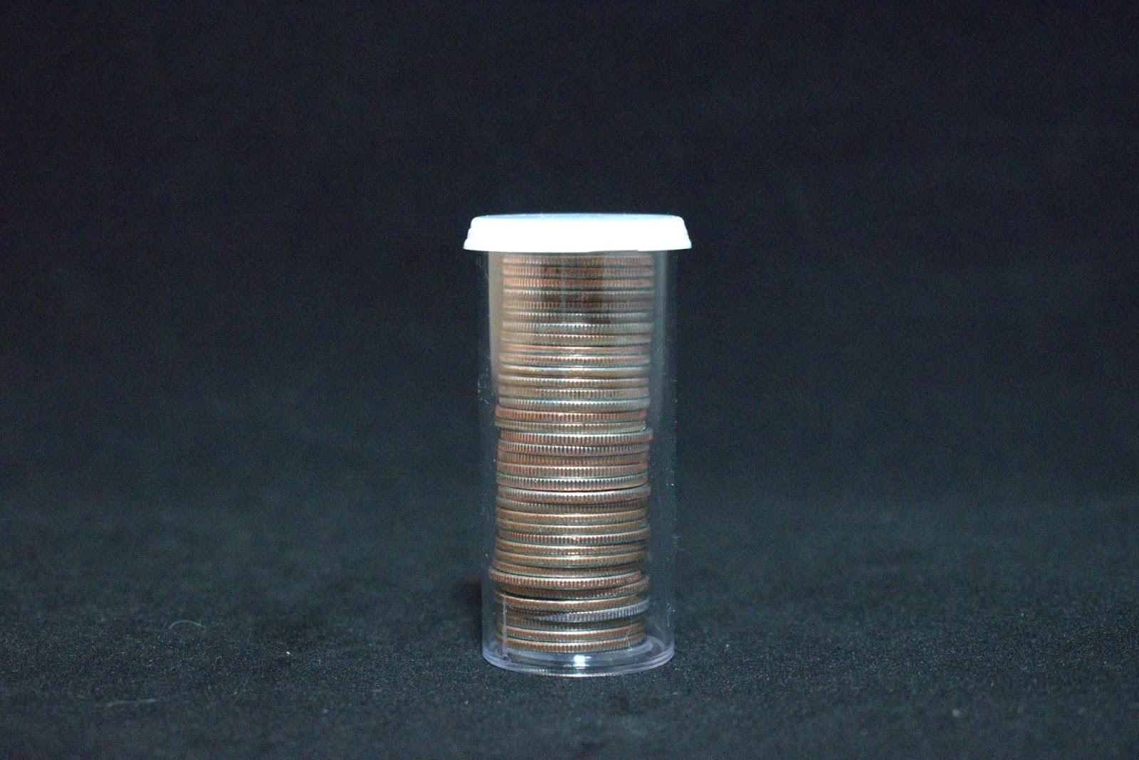 Stack of Quarters in a 9 Dram Vial